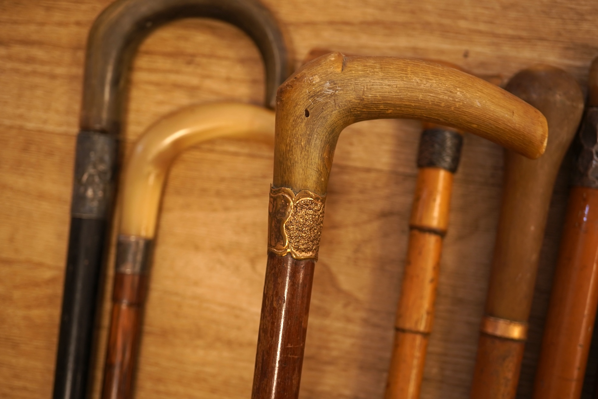 A collection of seven horn handles walking sticks some gold and white metal mounted